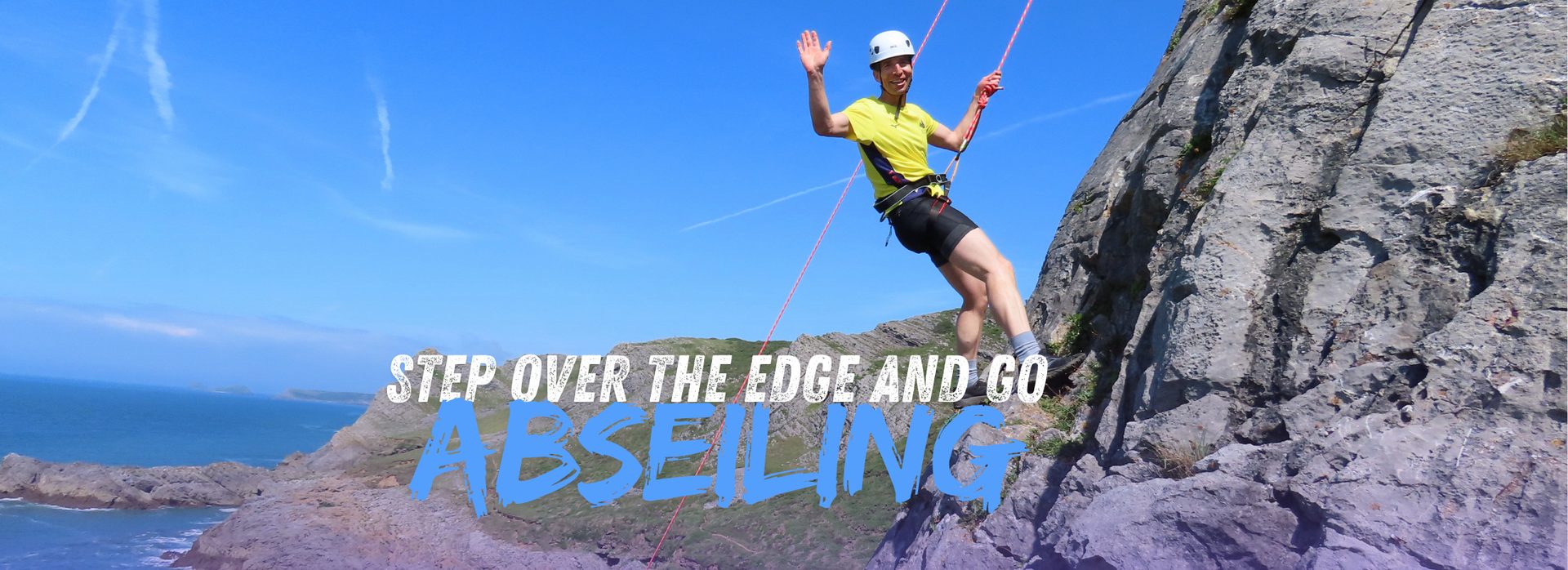 Abseiling down a coastal cliff
