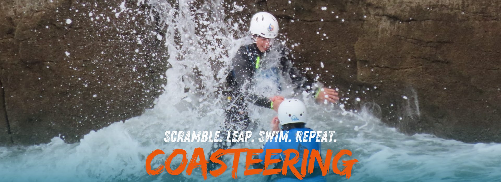 Coasteering group exploring sea caves